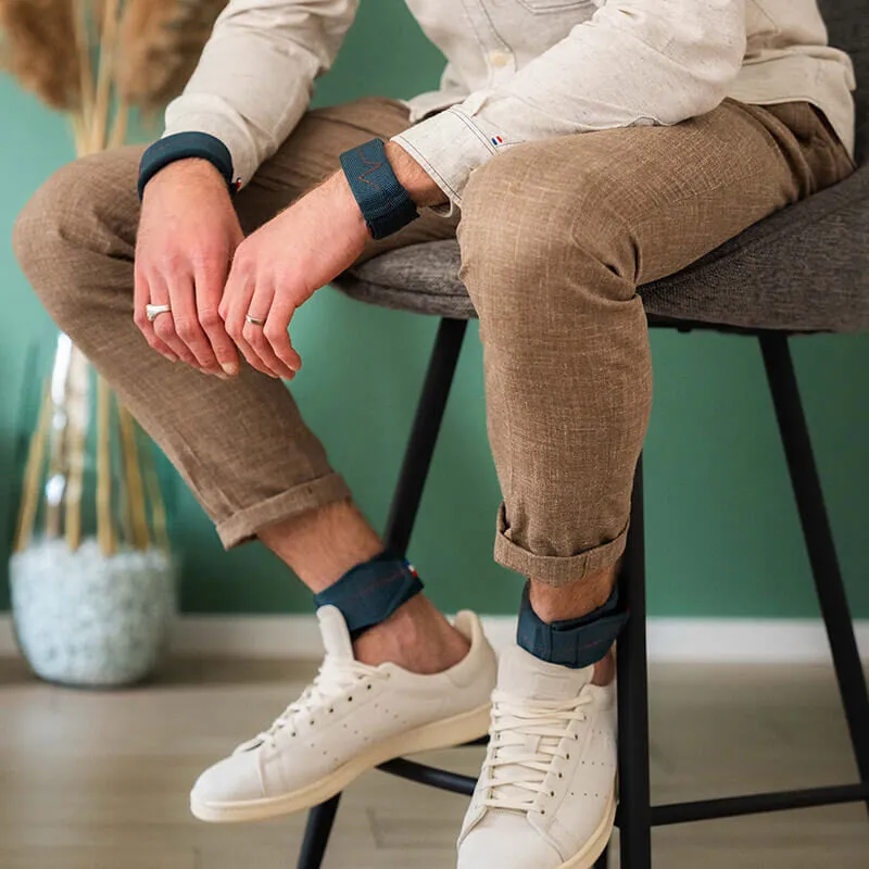 man sitting on chair with wrist and ankle weights - gentle gym equipment for office - strengthening accessories