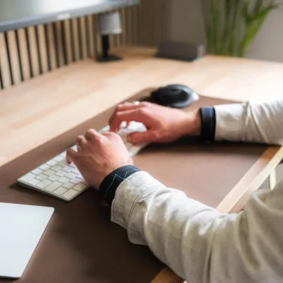 person sitting in the office with wrist weights - muscle strengthening while sitting in a chair - daily gentle exercise
