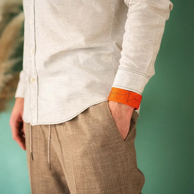 wrist weights worn daily - standing man with arm strength training accessory - gym at the office - arm workout at home