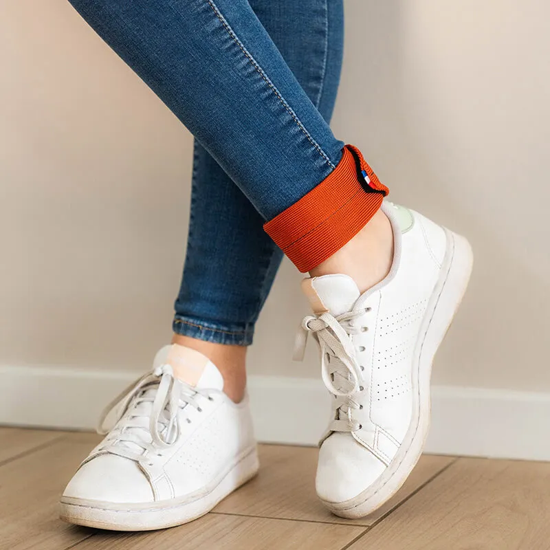 ankle weight bracelets - standing woman with discreet ankle weights - leg muscle strengthening - workout at the office